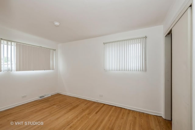 7912 W Lawrence Ave Unit C, Norridge, IL 60706 - unfurnished bedroom with light wood-type flooring, baseboards, and a closet