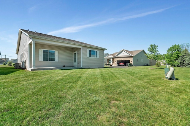 25626 S Geraldine Ct, Channahon, IL 60410 - rear view of house featuring central AC and a lawn