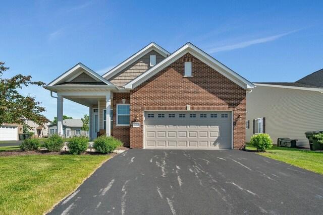 25626 S Geraldine Ct, Channahon, IL 60410 - view of front of home with a garage, driveway, brick siding, and a front lawn