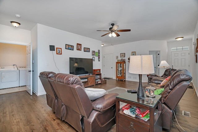 25626 S Geraldine Ct, Channahon, IL 60410 - living area with washer and dryer, a ceiling fan, wood finished floors, and baseboards