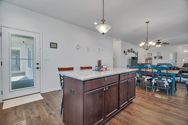 25626 S Geraldine Ct, Channahon, IL 60410 - kitchen with open floor plan, dark wood-style floors, a chandelier, hanging light fixtures, and dark brown cabinetry