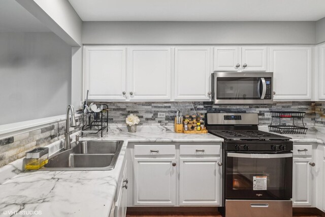 39642 N Warren Ln Unit 0, Beach Park, IL 60083 - kitchen featuring appliances with stainless steel finishes, a sink, and white cabinets