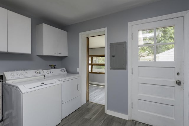 laundry area featuring electric panel, cabinet space, washing machine and clothes dryer, dark wood finished floors, and baseboards