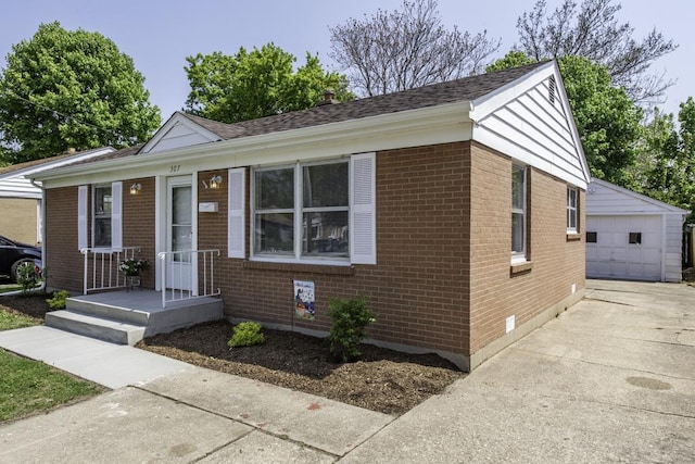 ranch-style home featuring brick siding, an outbuilding, a garage, and concrete driveway