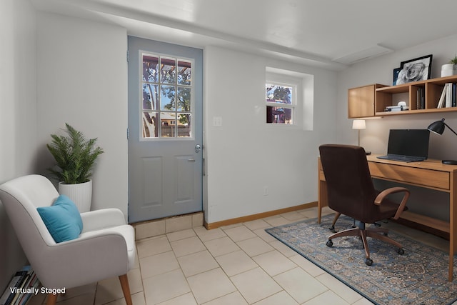 home office with plenty of natural light, light tile patterned floors, and baseboards