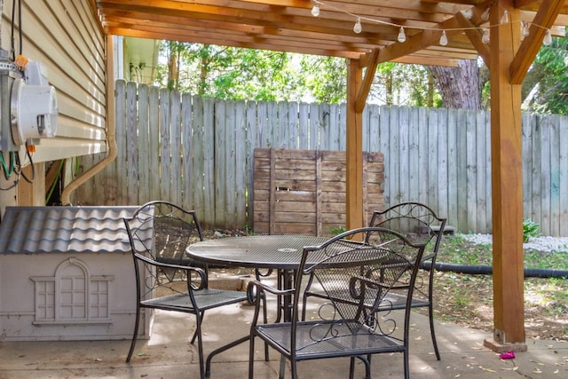view of patio with outdoor dining area, fence, and a pergola