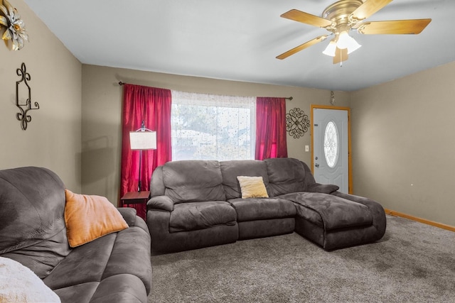 carpeted living room featuring a ceiling fan and baseboards