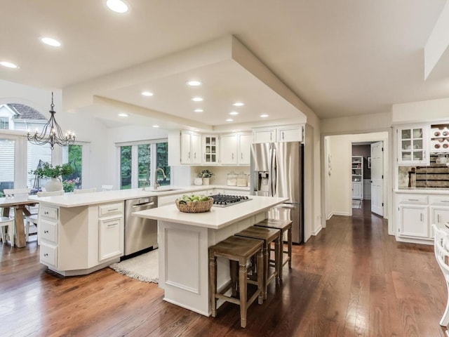 1664 Imperial Cir, Naperville, IL 60563 - kitchen with appliances with stainless steel finishes, a sink, a kitchen island, a chandelier, and glass insert cabinets