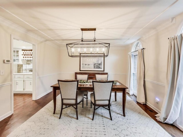 1664 Imperial Cir, Naperville, IL 60563 - dining area with wood finished floors, a chandelier, ornamental molding, and baseboards