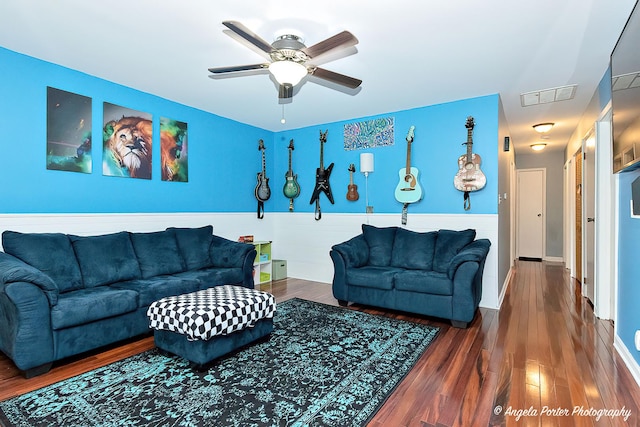 living area featuring a ceiling fan and wood finished floors
