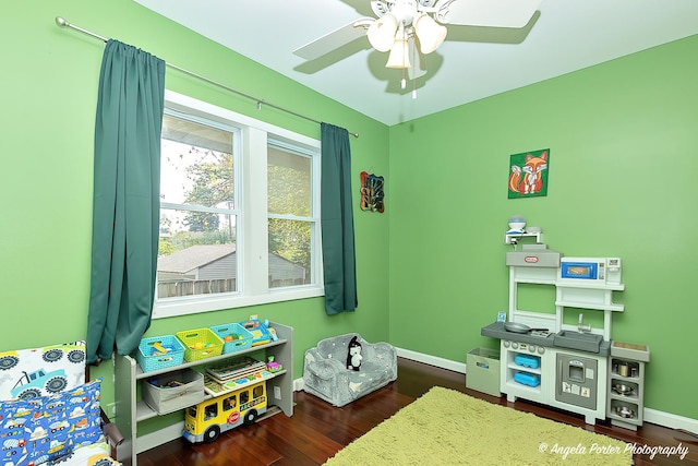 rec room featuring a ceiling fan, wood finished floors, and baseboards