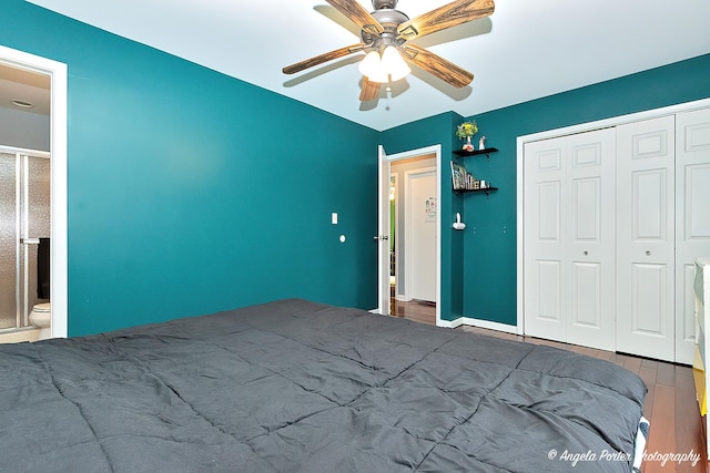 bedroom with wood finished floors, a closet, ceiling fan, and ensuite bathroom