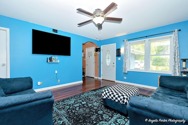 living area with wood finished floors, baseboards, and ceiling fan