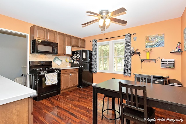 kitchen featuring black appliances, ceiling fan, dark wood-style floors, decorative backsplash, and light countertops