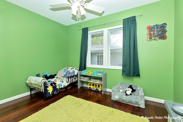 bedroom with wood finished floors and baseboards