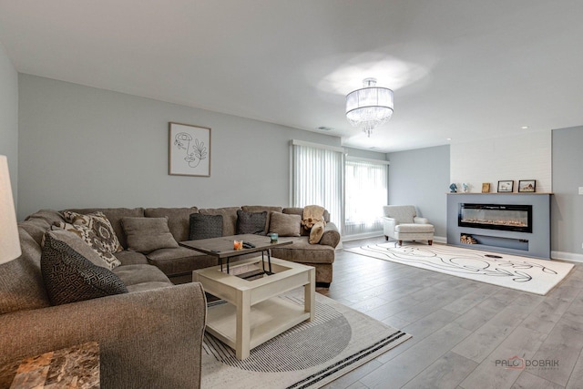 225 Lake Blvd Unit 546, Buffalo Grove, IL 60089 - living area featuring wood finished floors, a chandelier, and a large fireplace