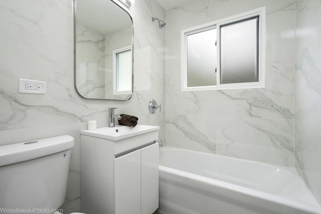 bathroom with toilet, vanity, and bathing tub / shower combination