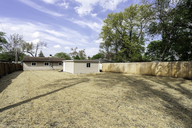 fenced backyard featuring an outdoor structure
