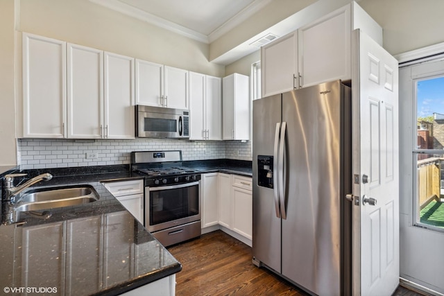 1460 W Ohio St Unit 3R, Chicago, IL 60642 - kitchen with stainless steel appliances, a sink, ornamental molding, white cabinetry, and backsplash