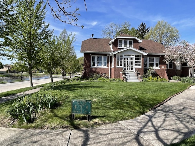 9600 W Shore Dr, Oak Lawn, IL 60453 - view of front of house featuring brick siding, a front lawn, and a water view