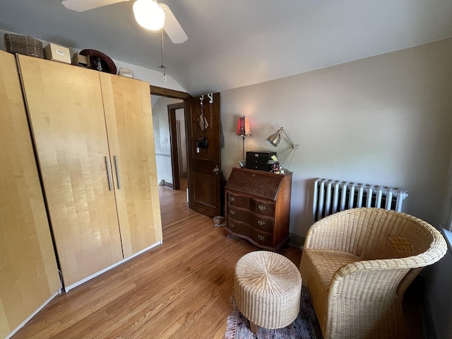 9600 W Shore Dr, Oak Lawn, IL 60453 - living area with radiator heating unit, wood finished floors, lofted ceiling, baseboards, and ceiling fan