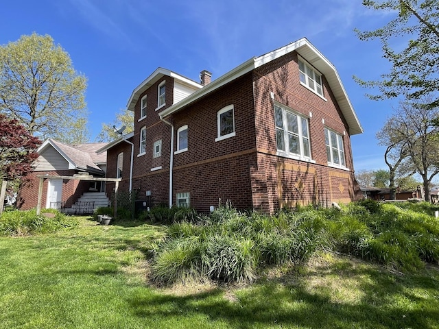 9600 W Shore Dr, Oak Lawn, IL 60453 - view of property exterior featuring brick siding, a yard, and a chimney