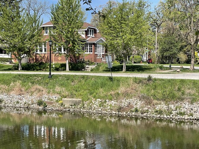 9600 W Shore Dr, Oak Lawn, IL 60453 - view of front facade featuring a water view and brick siding