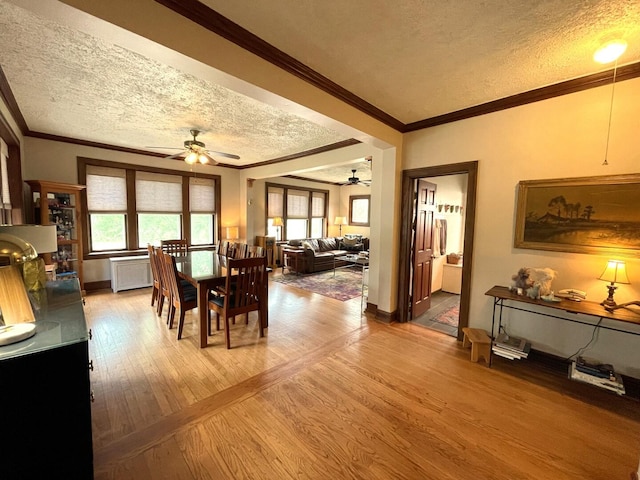 9600 W Shore Dr, Oak Lawn, IL 60453 - dining area with a textured ceiling, ceiling fan, light wood-type flooring, baseboards, and ornamental molding