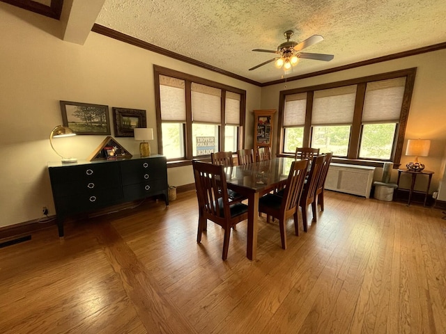 9600 W Shore Dr, Oak Lawn, IL 60453 - dining room with hardwood / wood-style flooring, crown molding, a textured ceiling, ceiling fan, and radiator heating unit