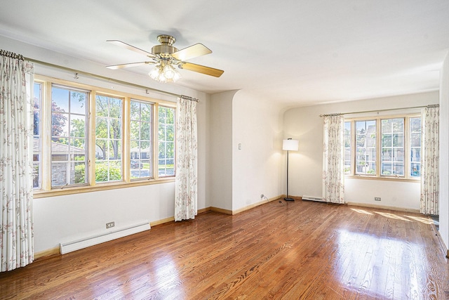 18333 Chicago Ave, Lansing, IL 60438 - empty room with a baseboard heating unit, plenty of natural light, wood finished floors, and a ceiling fan