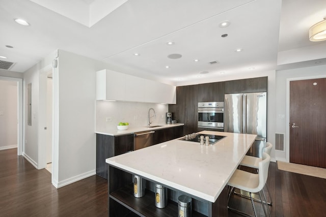 130 N Garland Ct Unit 3803, Chicago, IL 60602 - kitchen with modern cabinets, appliances with stainless steel finishes, baseboards, dark wood-style flooring, and a center island