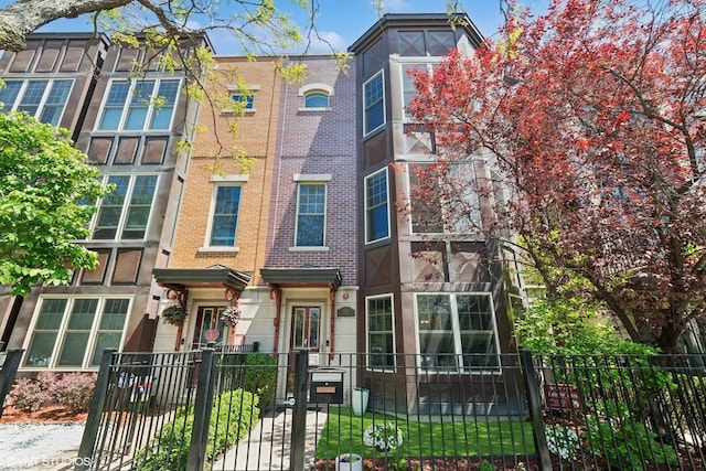 3447 N Whipple St, Chicago, IL 60618 - townhome / multi-family property with brick siding, a fenced front yard, and a gate