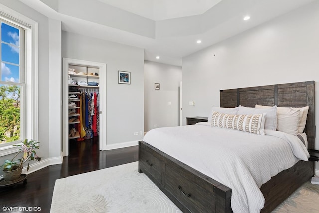 3447 N Whipple St, Chicago, IL 60618 - bedroom featuring dark wood-style flooring, multiple windows, recessed lighting, a walk in closet, and baseboards