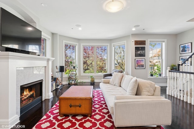 3447 N Whipple St, Chicago, IL 60618 - living room with a high end fireplace, wood finished floors, baseboards, and recessed lighting
