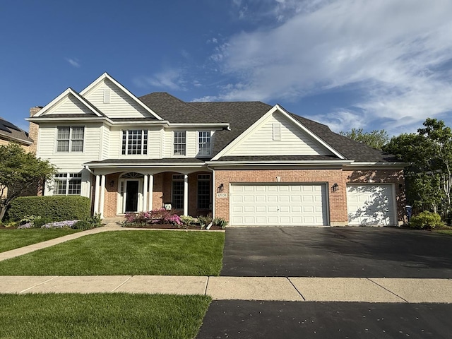 40W095 Carl Sandburg Rd, Saint Charles, IL 60175 - traditional-style home featuring a front yard, brick siding, asphalt driveway, a garage, and a porch