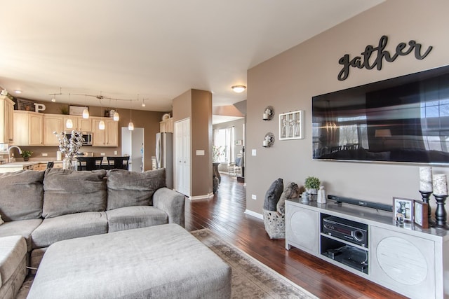 living room featuring dark wood-style flooring and baseboards
