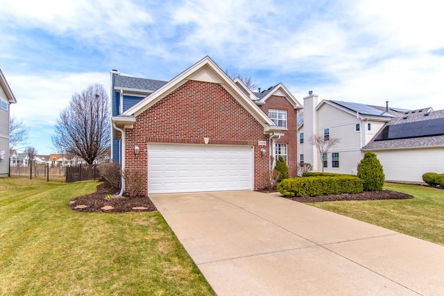 traditional home with brick siding, driveway, and a garage