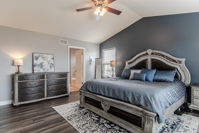 bedroom featuring lofted ceiling, dark wood-style floors, ensuite bathroom, and ceiling fan