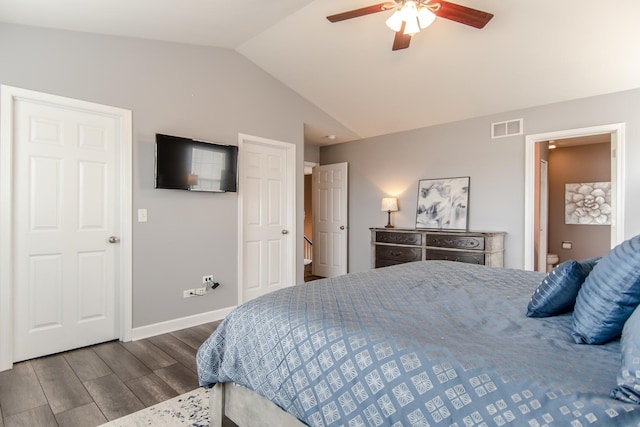 bedroom featuring lofted ceiling, wood finished floors, baseboards, and a ceiling fan