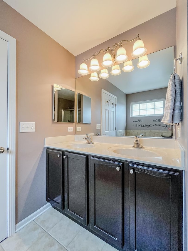 full bathroom featuring tile patterned floors, double vanity, and baseboards
