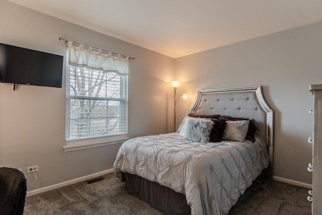 bedroom with carpet flooring, baseboards, and multiple windows
