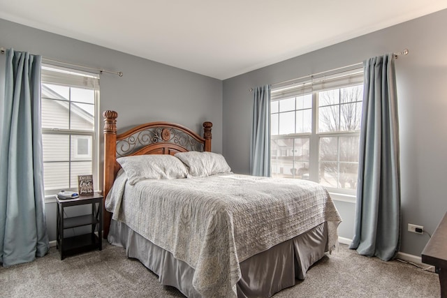 bedroom with light colored carpet and baseboards