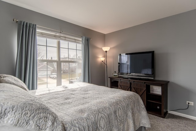 bedroom with carpet and baseboards