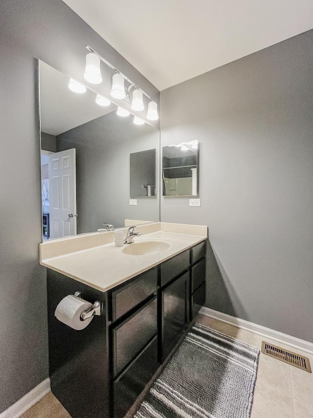 bathroom with baseboards and vanity
