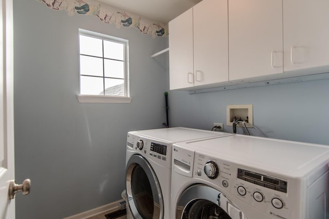 laundry room with cabinet space, independent washer and dryer, and baseboards