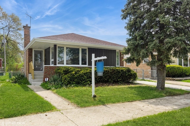 bungalow-style home with brick siding and a chimney