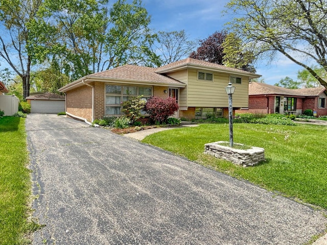 1048 Marshall Dr, Des Plaines, IL 60016 - split level home featuring brick siding, a front lawn, an outbuilding, and a garage