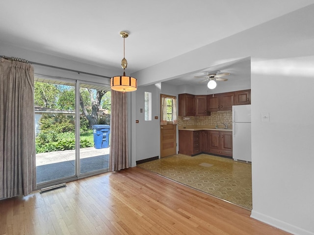 1048 Marshall Dr, Des Plaines, IL 60016 - kitchen featuring freestanding refrigerator, baseboards, light countertops, and light wood-style flooring