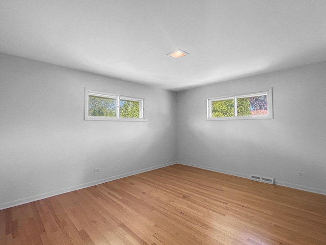 1048 Marshall Dr, Des Plaines, IL 60016 - empty room with plenty of natural light, light wood-type flooring, and baseboards