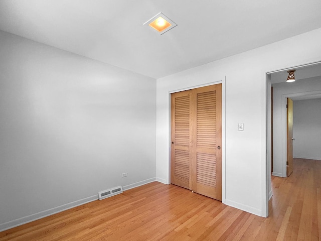 1048 Marshall Dr, Des Plaines, IL 60016 - unfurnished bedroom with baseboards, light wood finished floors, and a closet